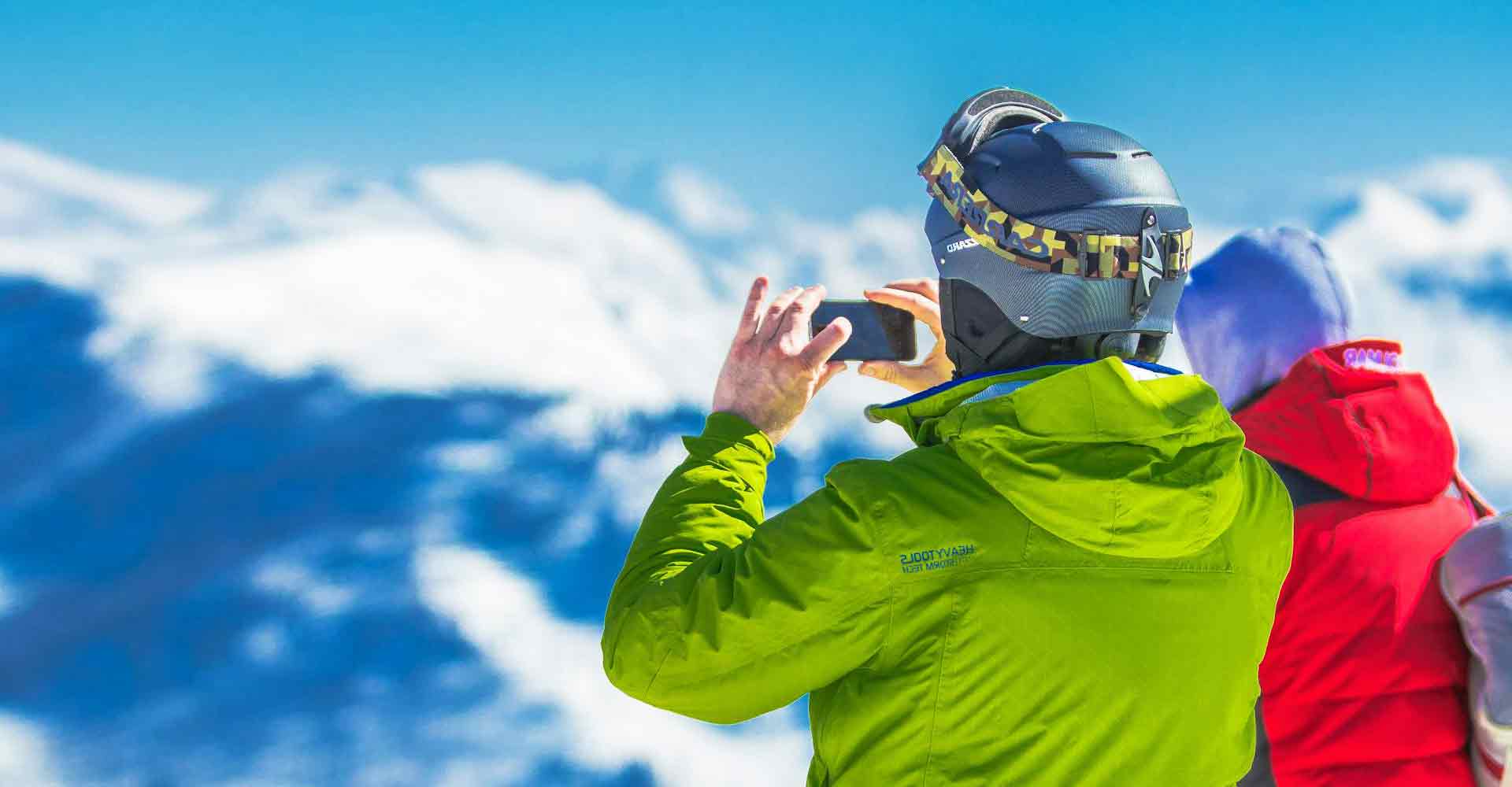 Tourists enjoying a scenic view at Mt Buller, capturing snowy mountain landscapes.